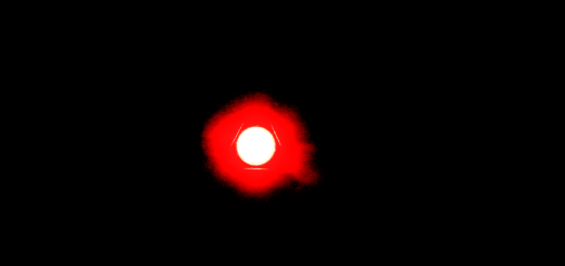 A sinsister glowing red light glowing in the darkness.